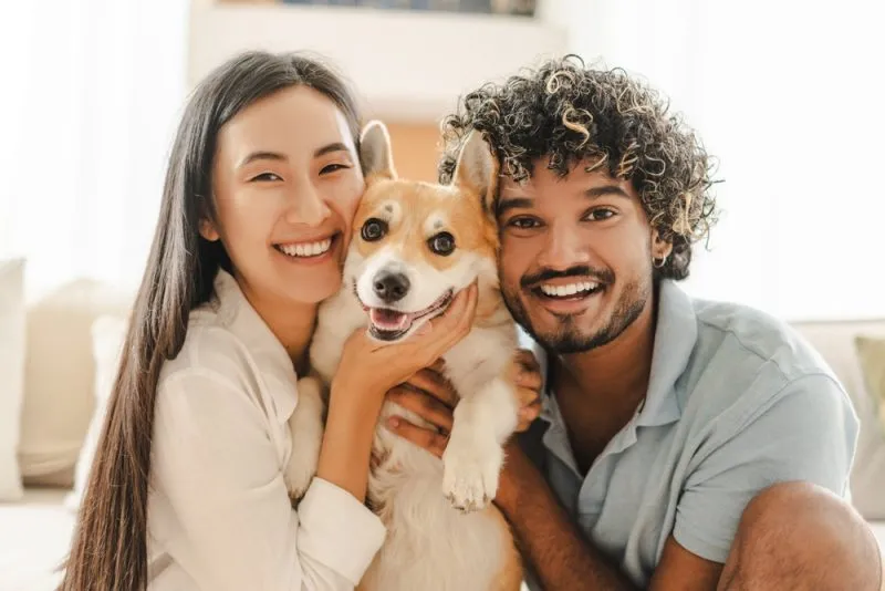 Smiling family with dog